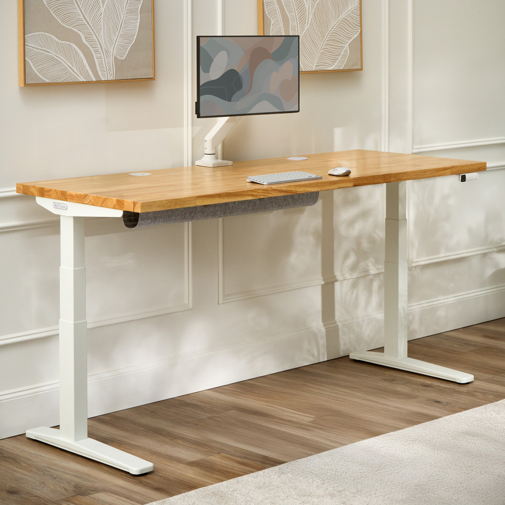 UPLIFT V3 standing desk with a light wood top and white frame